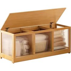 a wooden box with three compartments filled with towels