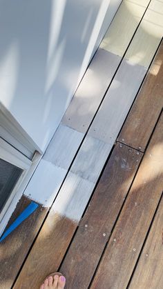 a person standing on top of a wooden deck