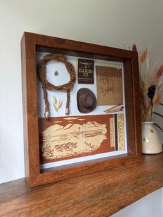 EVERYTHING IS BIGGER IN (THIS SHADOWBOX) TEXAS 🔥 The first piece made with a Giant Feature Matchbook and larger-than-normal handbraided lasso!  🤠 Rootin' Tootin' Western Matchbook Collage: Howdy, pardner! Introducing our one-of-a-kind rootin' tootin' western matchbook collage, the piece you've been waiting for! This rustic masterpiece measures 9"x9" with outer frame measurements of 10"l x 10"w x 1.75"d, and it's sure to bring some Yee-Haw onto your walls. 🌾 Capture the Spirit of the Wild West Horse Tail Shadow Box Ideas, Western Wall Hangings, Cowboy Diorama, Framed Wall Collage, Matchbook Collage, Lasso Rope, Horse Wall Decor, Nashville House, Rootin Tootin