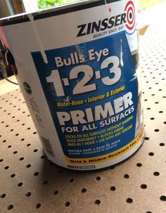 a can of primer for all surfaces sits on a shelf in a store or office