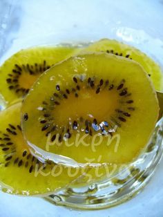 two pieces of kiwi sitting in a glass bowl