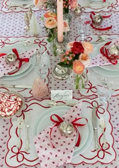 a table set for valentine's day with place settings