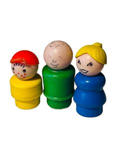 three wooden toys with faces painted on them