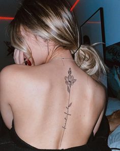 a woman with a flower tattoo on her back