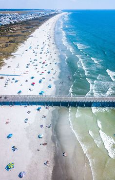 an aerial view of the beach and pier