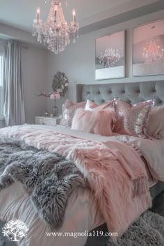 a bedroom decorated in pink and grey with a chandelier