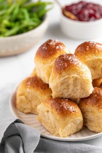 rolls on a plate with cranberry sauce in the background