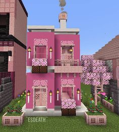 a pink house with lots of windows and flowers