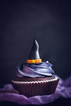 a cupcake with a witches hat on top