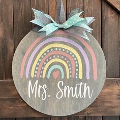 a wooden sign that says, mrs smith with a rainbow and heart on the front