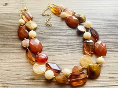 One of a kind! Beautiful styles of brown and gold acrylic beads on a chunky beaded necklace.  16 Inch Necklace with a 4 inch gold extender chain and gold lobster clasp. Thank you for supporting American small business! 100% handmade. *Smoke and pet free home!* Hate to wait? Me too! I ship 6 days a week. Thank you for browsing my store! Check out my other items here: https://www.etsy.com/shop/PolkaDotDrawer?ref=si_shop Luxury Brown Oval Beaded Necklace, Gold Chunky Necklace, Brown Beaded Necklace, 16 Inch Necklace, Jewelry Resin, Resin Beads, Chunky Necklace, Brown Butter, Acrylic Beads