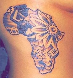 the back of a woman's stomach with tattoos on her body and flowers in it