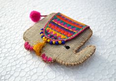 an elephant brooch with colorful beads and tassels