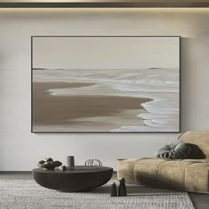 a living room with a couch, coffee table and large painting on the wall above it