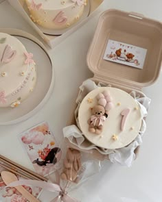 a table topped with lots of cakes and cupcakes