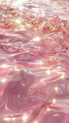 the water is pink and shiny with some light on it's surface, as well as bubbles