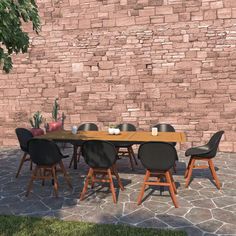 a wooden table with black chairs sitting in front of a brick wall next to a tree