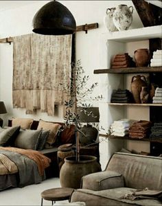 a living room filled with lots of furniture and decor on top of bookshelves