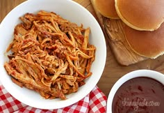 a bowl of pulled pork next to some pancakes