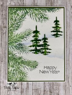 a christmas card with pine trees and the words happy new year