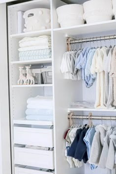 an organized closet filled with baby clothes and blankets, including ones that have been folded