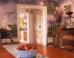 a bowl of food sitting on top of a dining room table next to a doorway