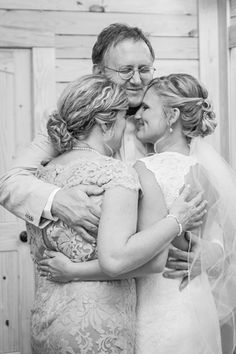 the bride and her mother hugging each other