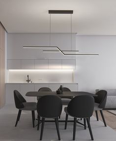 a modern dining room with black chairs and white walls