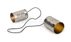 two tin canisters sitting next to each other on a white surface with wires