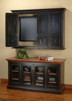 an entertainment center with cabinets and books on top