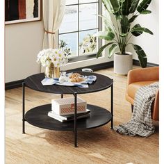 a living room scene with focus on the coffee table and chair, which has a potted plant