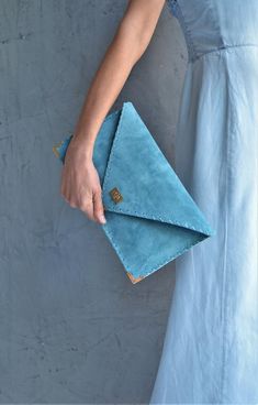 Soft Symmetria Clutch in jeans blue.The perfect bag for all occasions!Ideal for cocktail and parties or for business meetings depending the size you choose. It comes in two sizes, small and large.You can use it as a chic briefcase for your work or as a modern large clutch for a night out.This adorable large clutch is handmade out of a genuine, lux Italian jeans blue suede leather.-Small size fits all your essentials, wallet, keys, mobile, cosmetics etc. -Large size fits a 15" laptop, ipad, porto Modern Blue Leather Clutch, Blue Envelope Bag For Daily Use, Blue Leather Chic Clutch, Blue Chic Leather Clutch, Formal Blue Envelope Clutch, Blue Envelope Clutch For Everyday Use, Blue Rectangular Clutch For Everyday, Blue Clutch Bag, Formal Bag