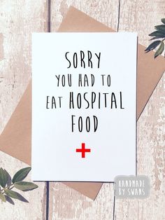 a card with the words sorry you had to eat hospital food on it next to some leaves