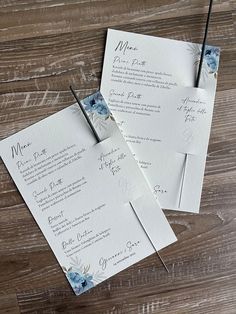 wedding stationery with blue flowers on them