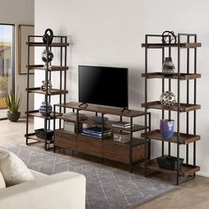 a living room with an entertainment center and bookshelves