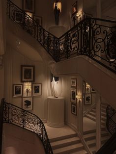 a staircase in a house with pictures on the wall