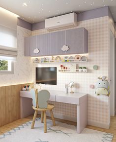 a child's room with a desk, chair and television on the wall in it