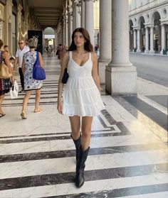 White Dress Black Boots Aesthetic, Dresses With Boots Summer, Minimalist Cowboy Boots Outfit, White Mini Dress And Cowboy Boots, Mini Dress And Cowboy Boots Outfit, White Cowboy Boots Outfit Aesthetic, Dress Boots Outfit Summer, Dress With Black Cowgirl Boots, Black Cowboots Outfits