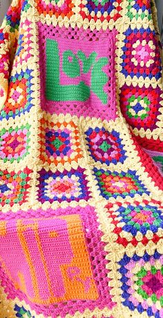 a colorful crocheted blanket sitting on top of a table