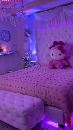 a hello kitty themed bedroom with purple lighting and chandelier above the headboard