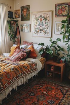 a bed sitting in a bedroom next to a window with lots of pictures on the wall