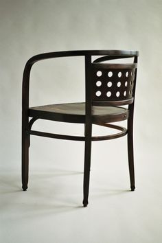 a wooden chair with holes in the back