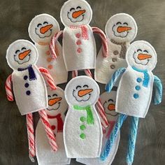 six snowmen with candy canes in their hands