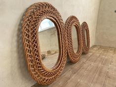 three round mirrors are sitting on the floor