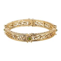 The thin gold tone links are stamped with a flowing filigree pattern and curve just perfectly to fit your wrist. Four flowers are placed along the stretch bracelet each as a petite olive-green crystal at the center for a simple pop of color. Four flowers accented with olivine green crystals Intricate filigree details on a gold-tone frame Measurements: 7"L x 0.25"W. Stretchable bracelet for the perfect fit. 1928 Jewelry Collection From the vaults of rich European capitals to the antique-laden att Simple Pop, European Jewelry, 1928 Jewelry, Filigree Pattern, Vintage Inspired Jewelry, Jewelry Accessories Ideas, Vintage Style Jewellery, Jewelry Lookbook, Green Crystal