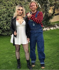 a man and woman dressed up in costumes posing for the camera with their hands on each other's hips