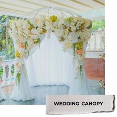 the wedding canopy is decorated with flowers and greenery