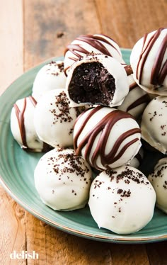 a plate full of chocolate covered desserts on a wooden table