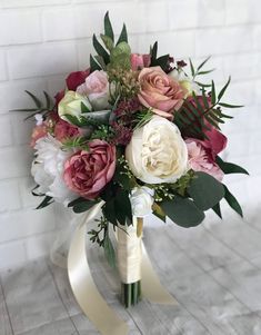 a bridal bouquet with pink and white flowers