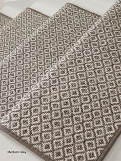 two brown and white rugs sitting on top of a table